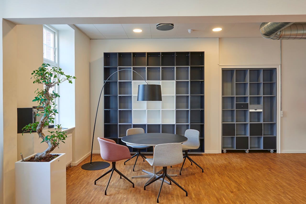 about-01 Bright and stylish office space with contemporary furniture and open shelving.